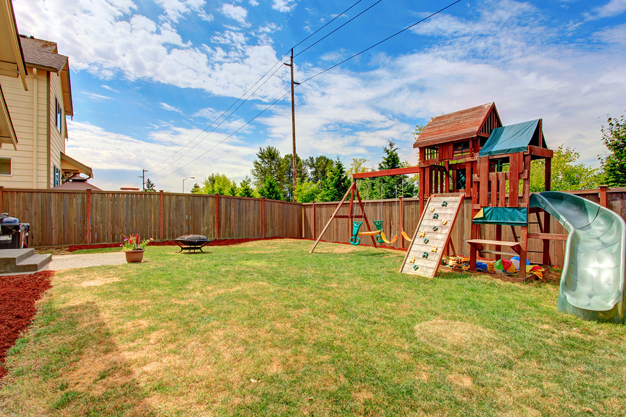 Fenced Backyard With Playground For Kids