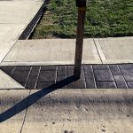 Black brick curbing on edge of sidewalk