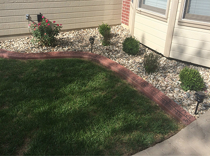 Red brick curbing near rock garden