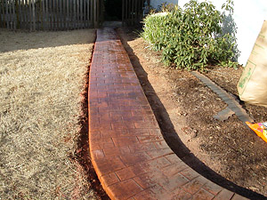 Red brickwork through grass to back wooden gate